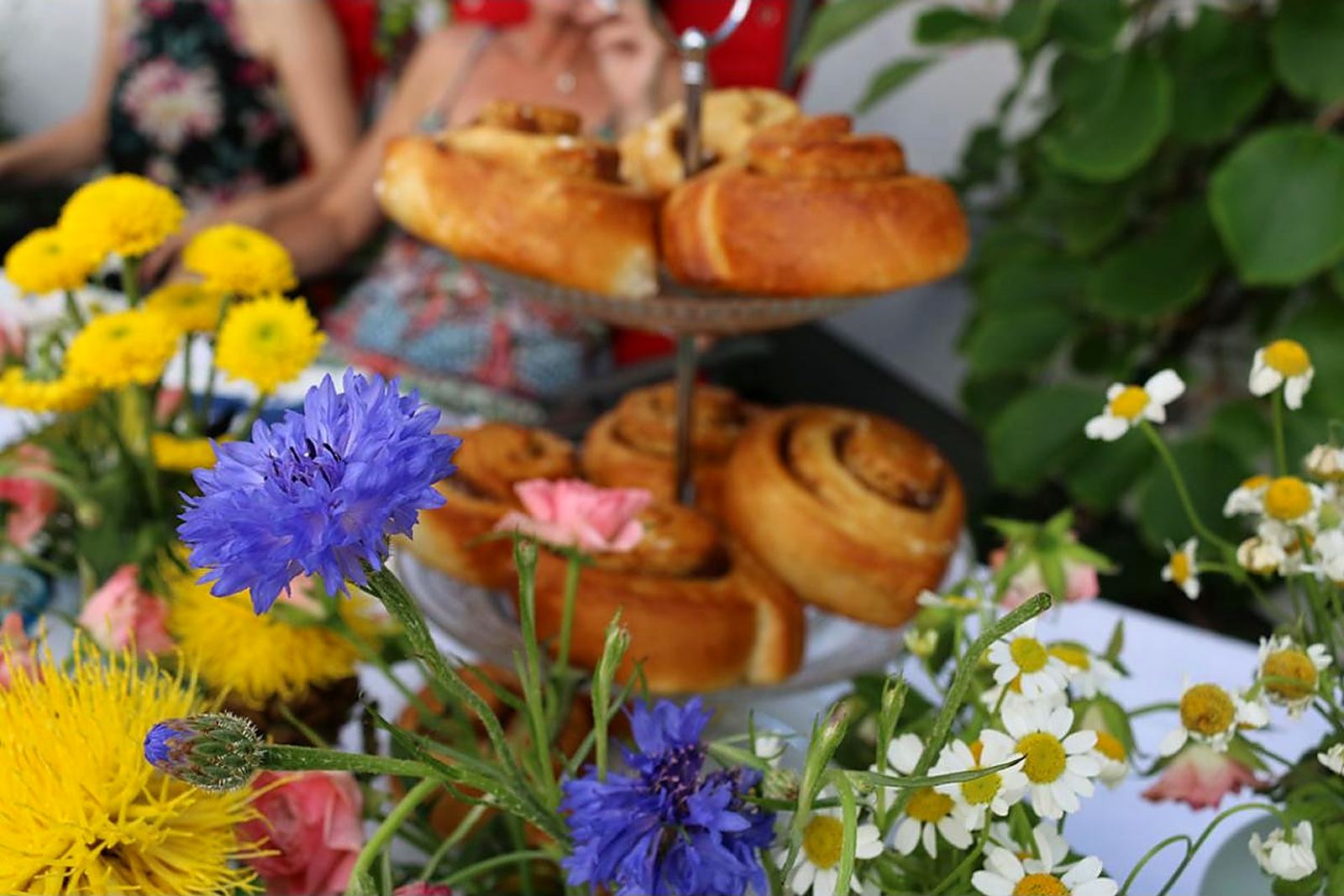 Gedeckter Tisch mit Blumen und Gebäck